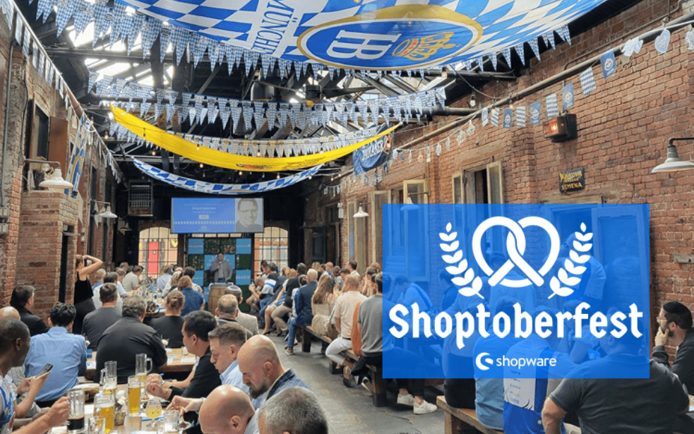 Großes Networking-Event mit Shopware Partnern in Oktoberfest-Atmosphäre – Teilnehmer sitzen in rustikaler Location unter blau-weißer Deko